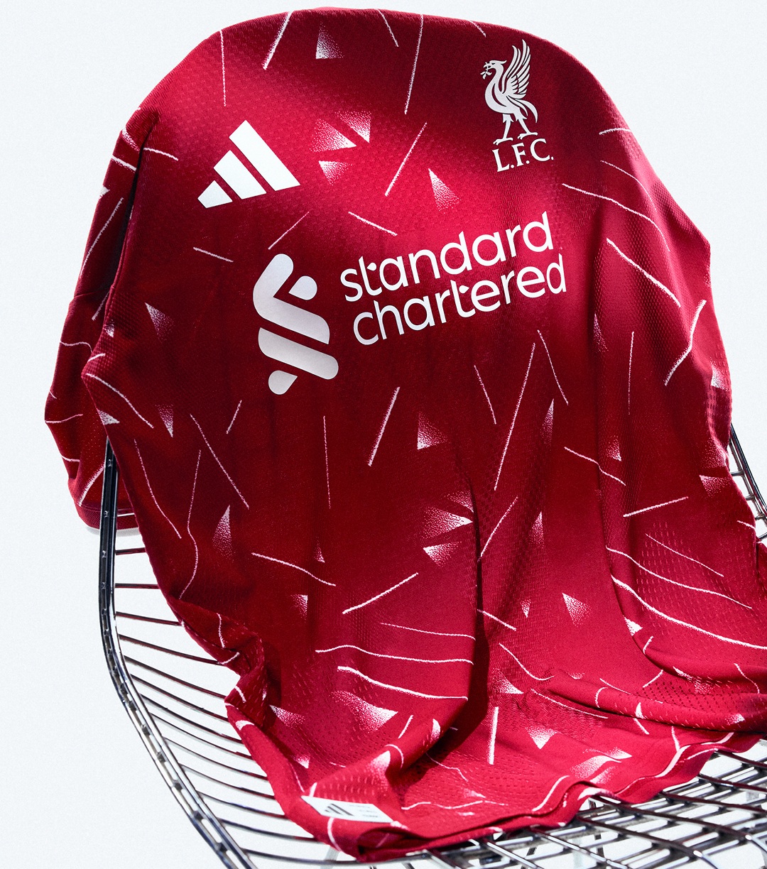 Deep red Liverpool FC home jersey by adidas with white club crest and standard chartered sponsor, plus an all-over geometric pattern and 3-stripes trims. - Totalsports